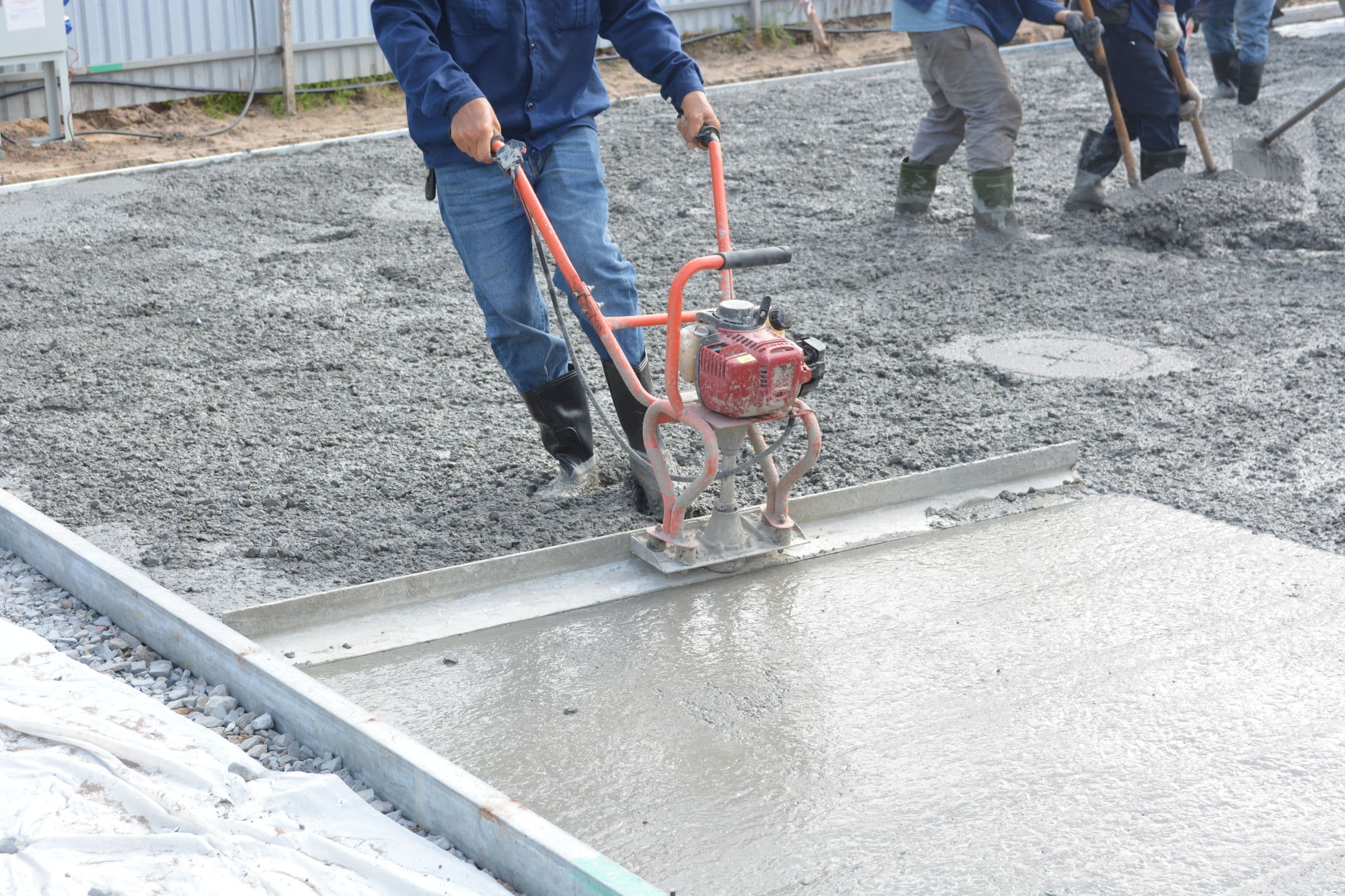 L & P crew power-screeding a freshly poured commercial slab